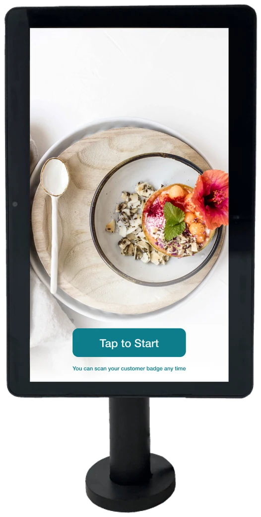 Self-service kiosk with a teal Tap to Start screen and a plated dish