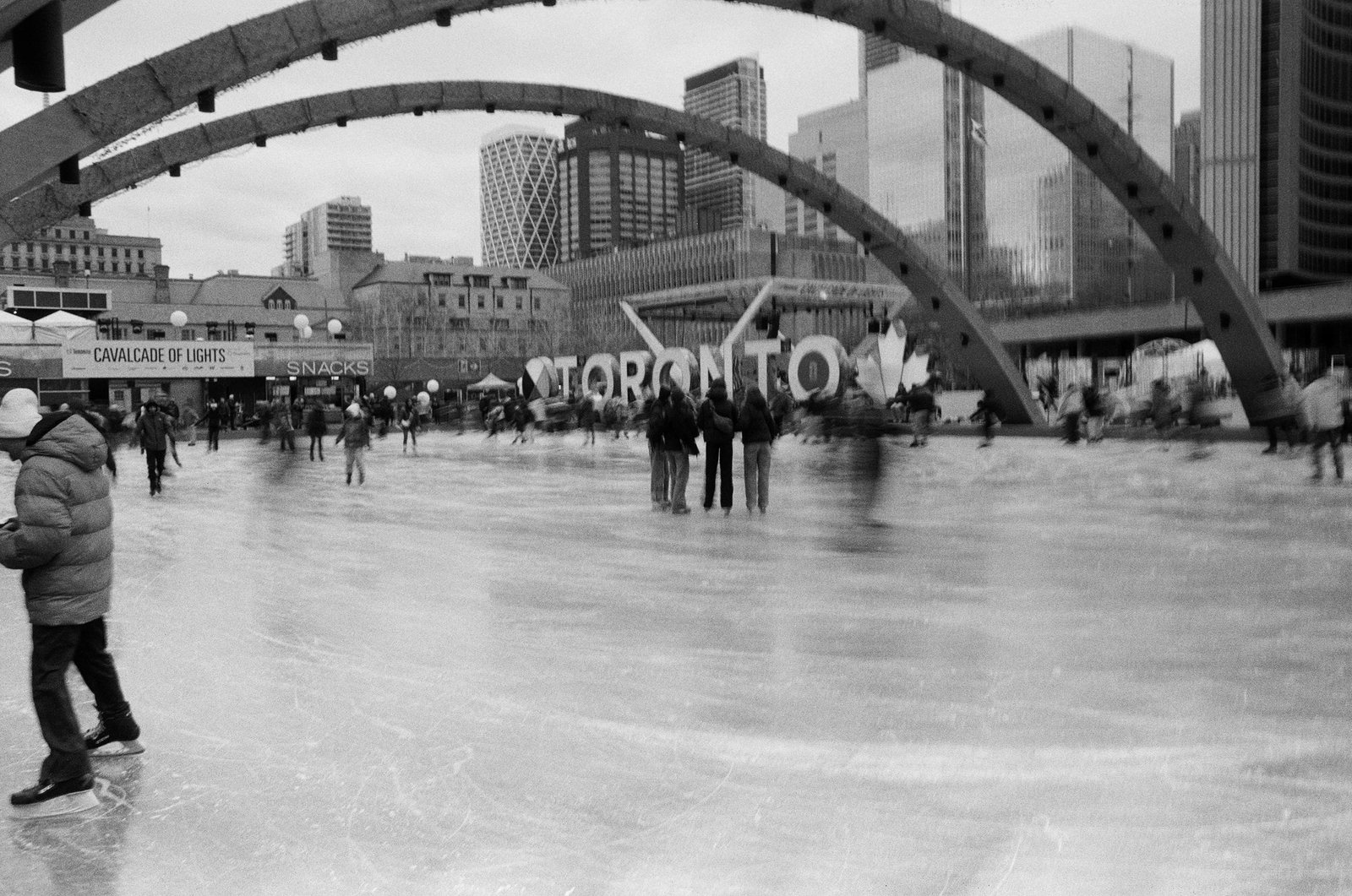 People skating beneath the Toronto sign at Nathan Phillips Square