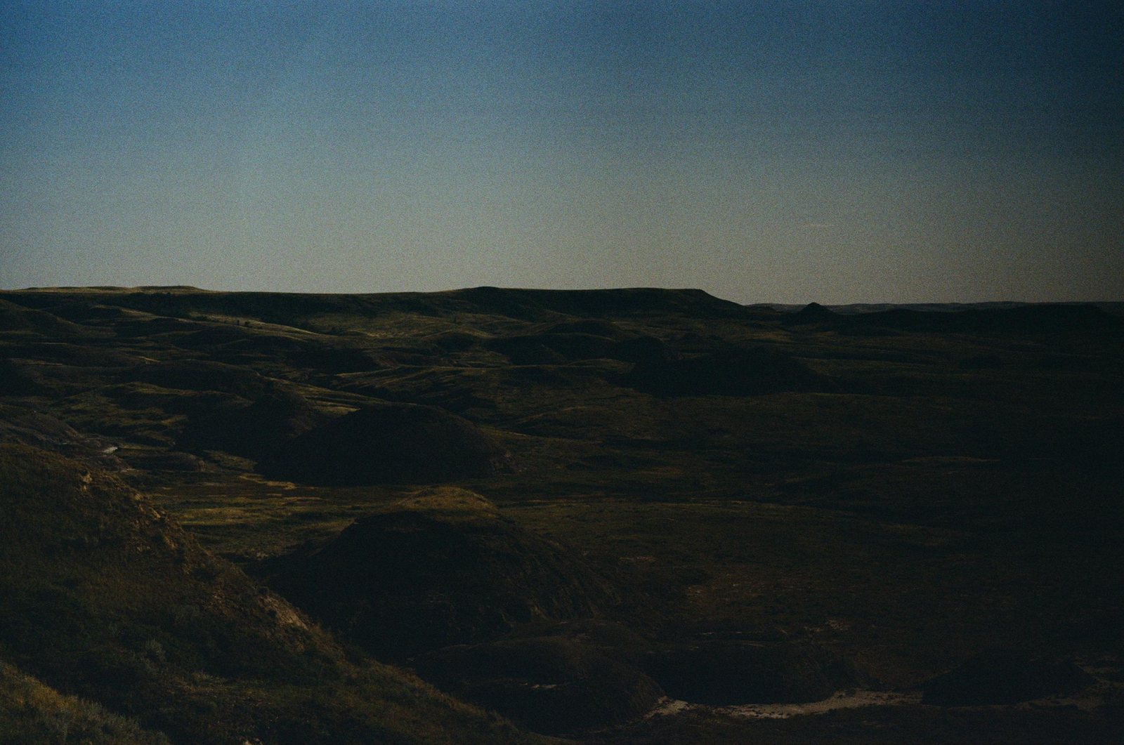 Low hills under a deep blue evening sky