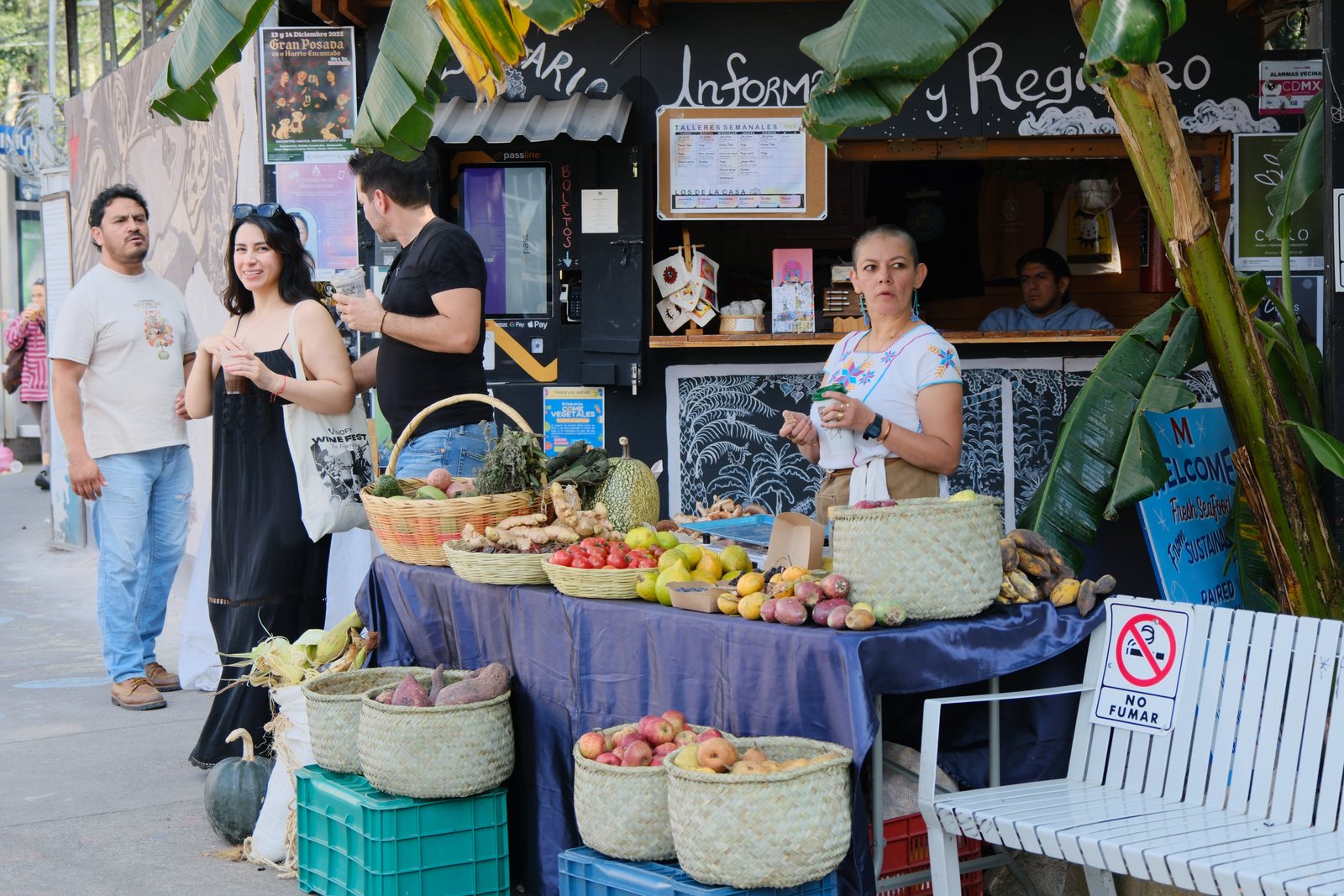 People gathered around an outdoor produce stall